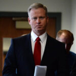 George Brauchler walking in a court room